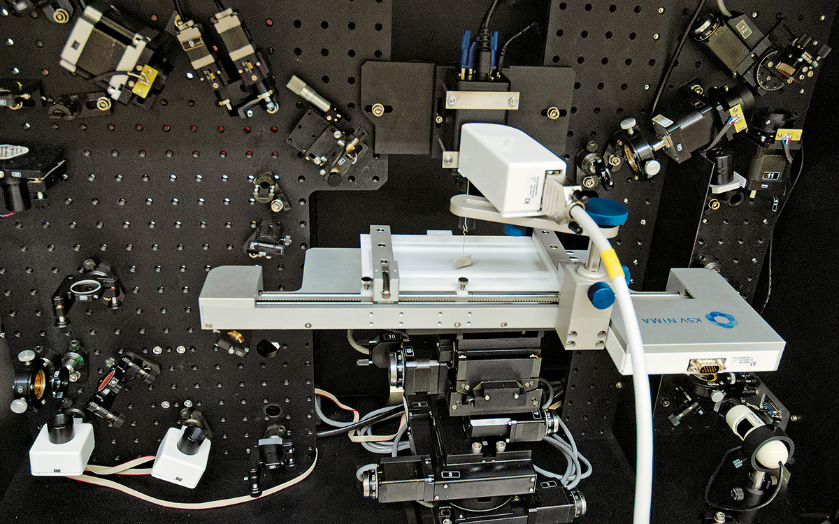 SFG spectrometer with Langmuir trough used for studies of the unique properties of molecules in monolayers